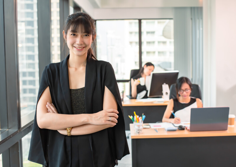 confident asian young businesswoman standing in modern office.